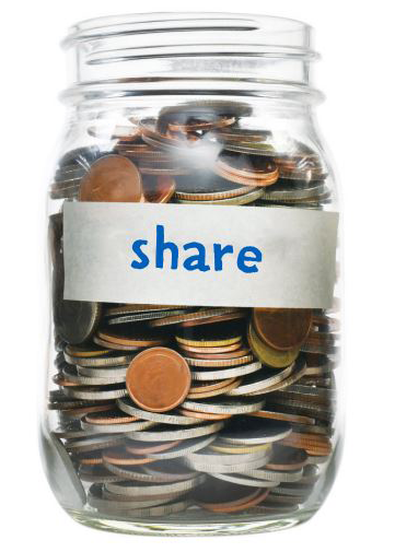Mason jar filled with coins with "Share" written on piece of masking tape stuck to outside